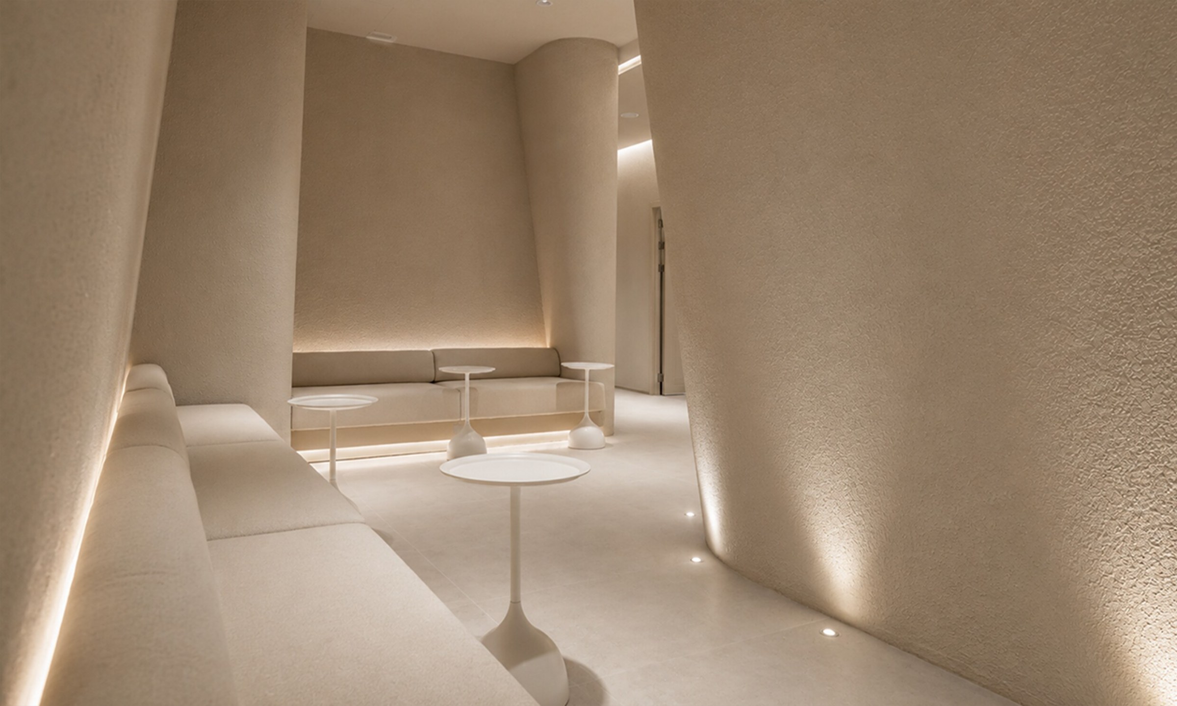 Beige waiting area with curved walls and sofas