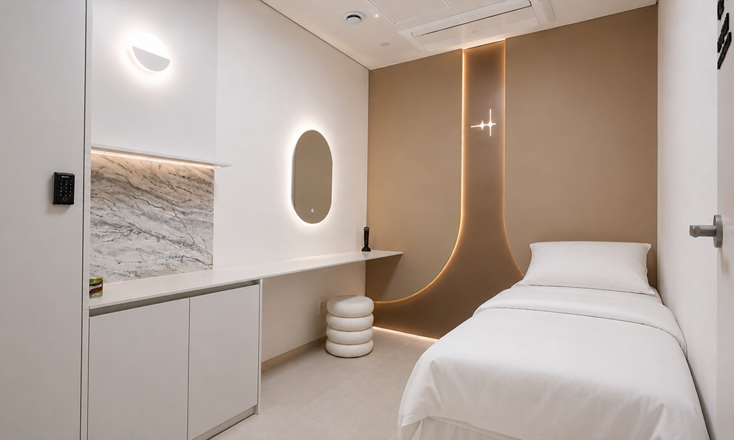 Beige-toned recovery room with a white bed and round mirror