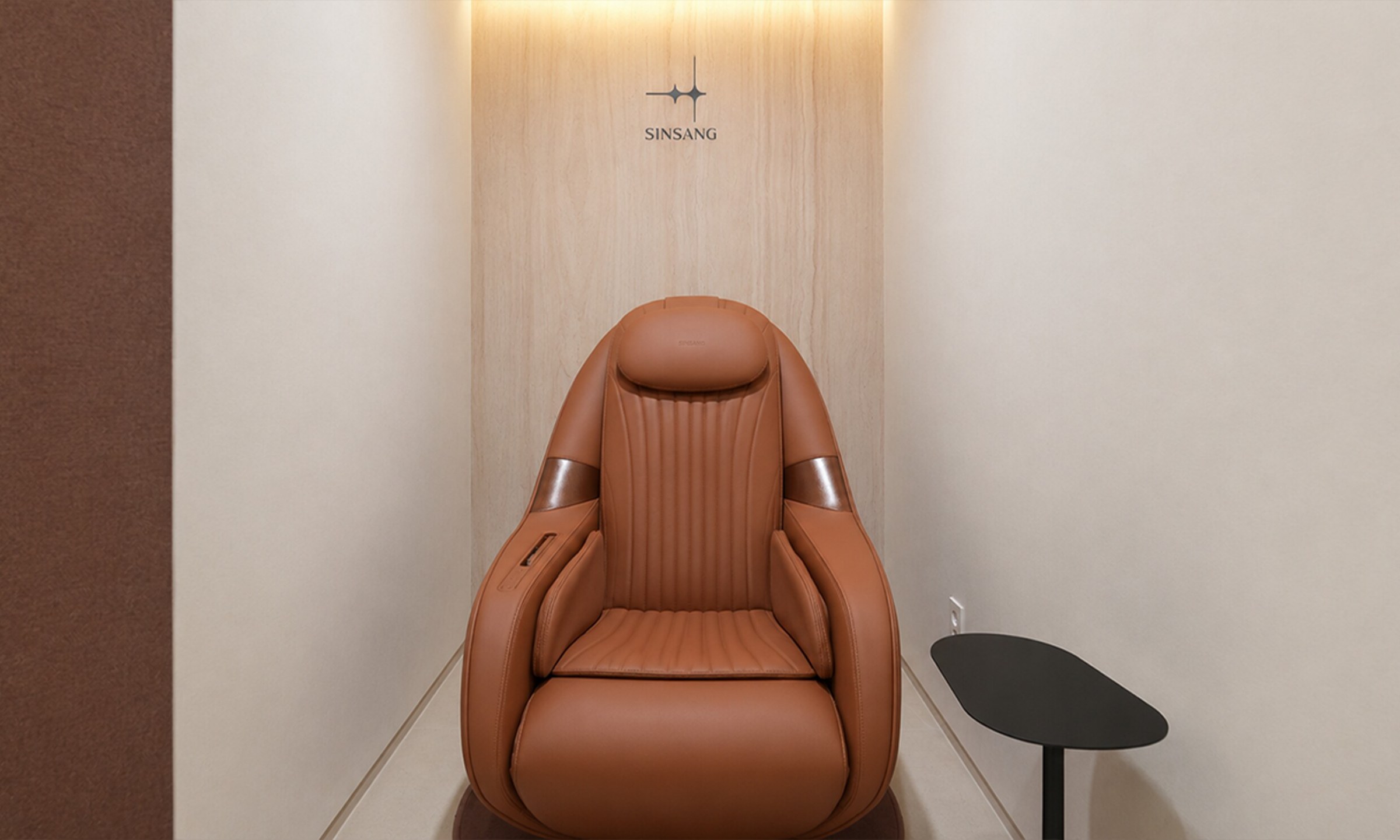 Rest booth with a brown leather massage chair