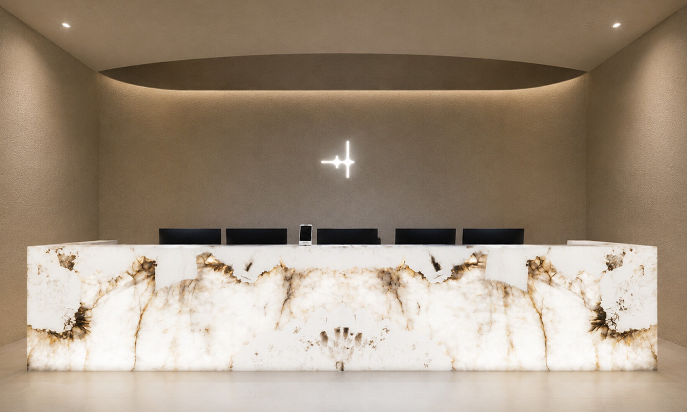 Reception desk with a white onyx top and logo sign
